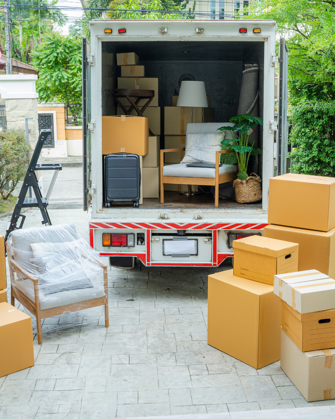 Moving truck and packed boxes representing a downsizing move